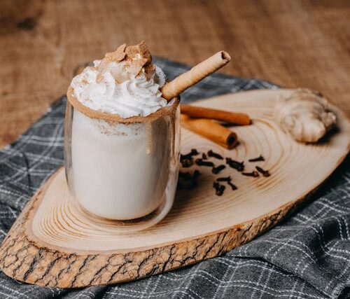 A rich cinnamon vanilla latte infused with cannabis, served in a mug with a cinnamon stick garnish.